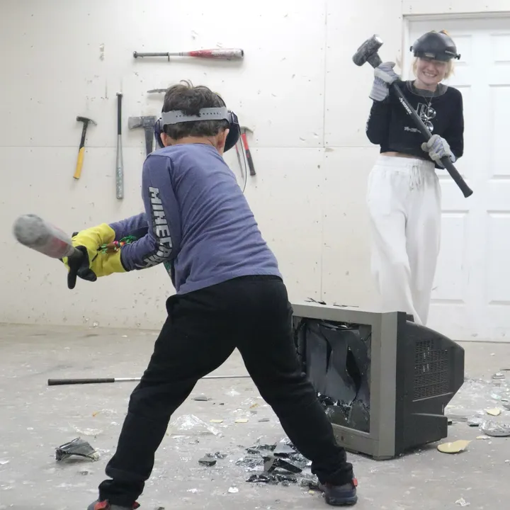 Breaking an old TV with a hammer at The Smash Room Tulsa